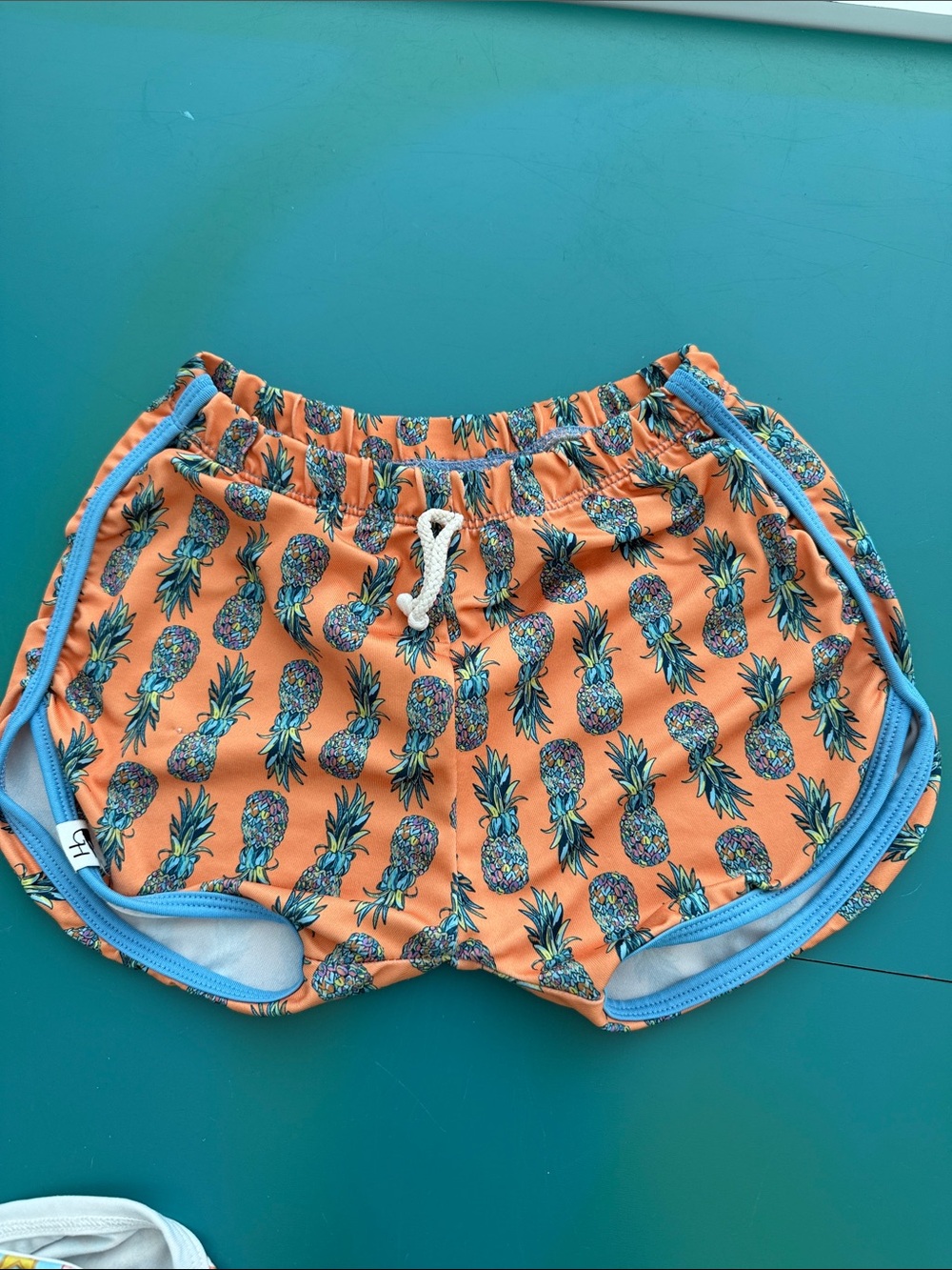 Kids Orange Pineapple Swim Trunks with Blue Trim